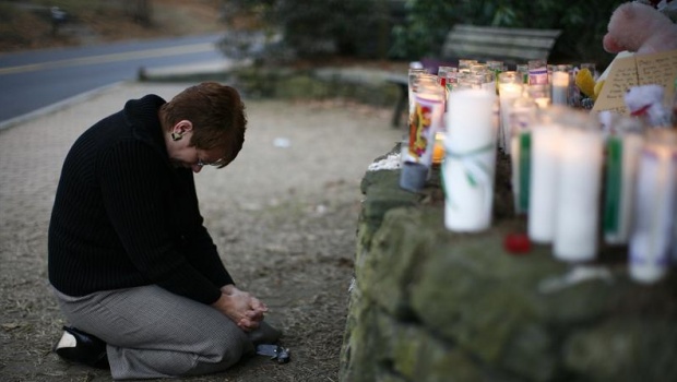A woman reacts at a memorial near Sandy Hook Elementary School in Newtown