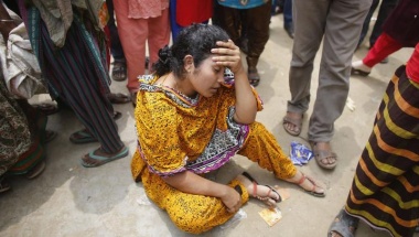 A woman mourns for her relative, a garment worker who died in the collapse of the Rana Plaza building, in Savar, 30 km (19 miles) outside Dhaka