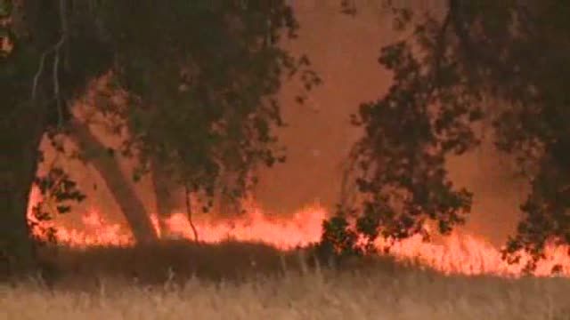 California wildfire spreads, but homes out of danger