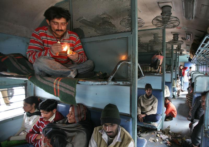 A commuter smokes inside a passenger train in Jammu