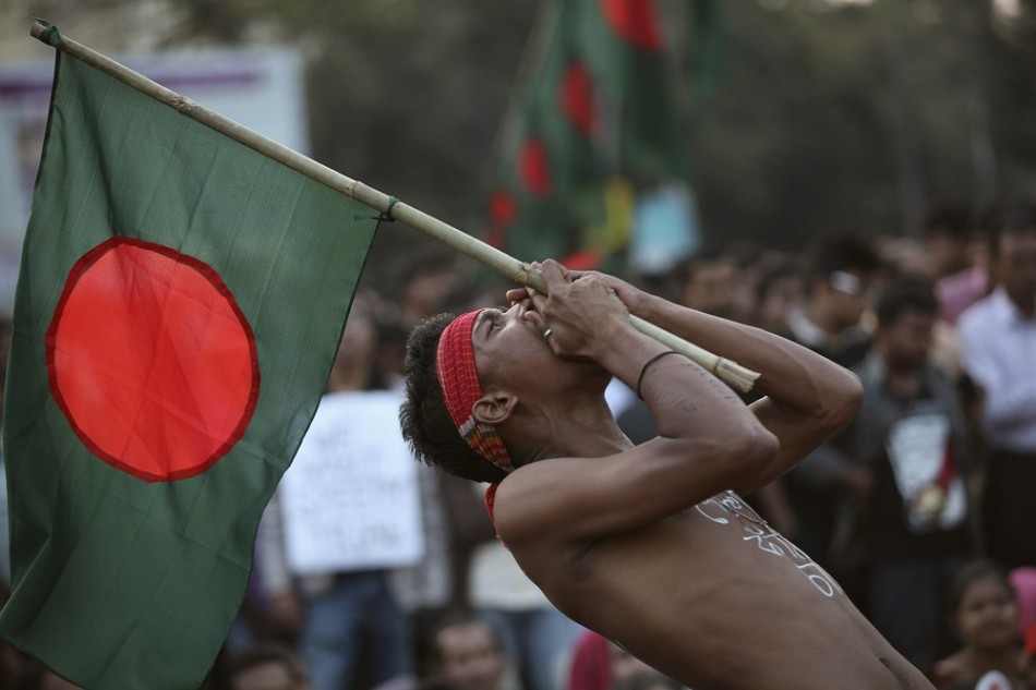A man chants slogans as he attends a sit-in protest demanding capital punishment for Jamaat-e-Islami's senior leader Abdul Quader Mullah (Reuters)