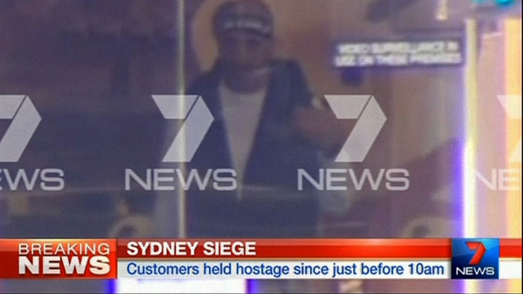 This image taken from video shows a man believed to be a gunman inside a cafe in Sydney