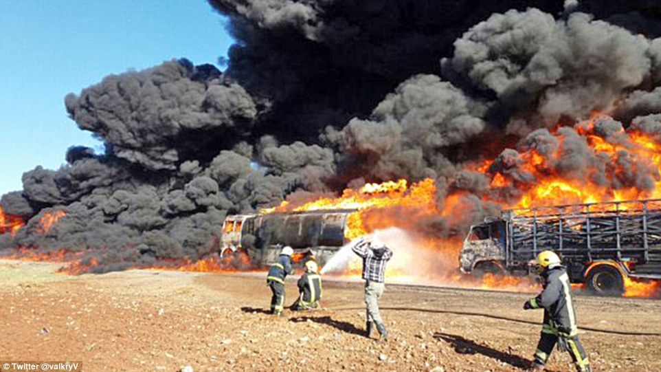 Up in smoke: ISIS oil convoy is obliterated by Russian air strike in Syria days after Putin said Turkey was buying it from Islamists